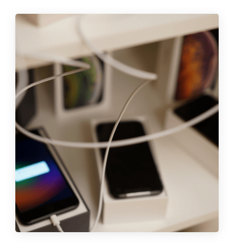 iPhone charging leads and an iPhone being charged